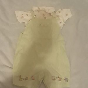 Pale green jumpsuit, cream colored polo